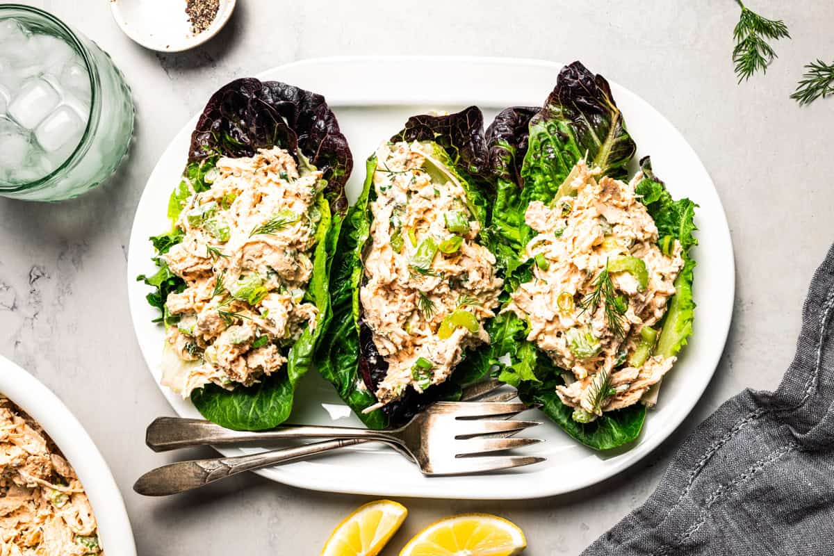 Chicken salad in lettuce cups arranged on a plate.