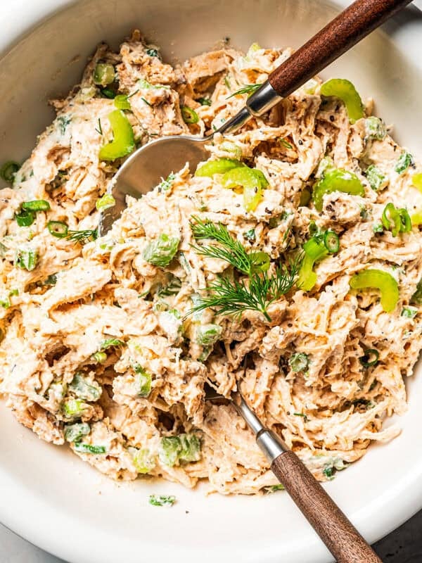 Cottage cheese chicken salad in a bowl with two wooden spoons.