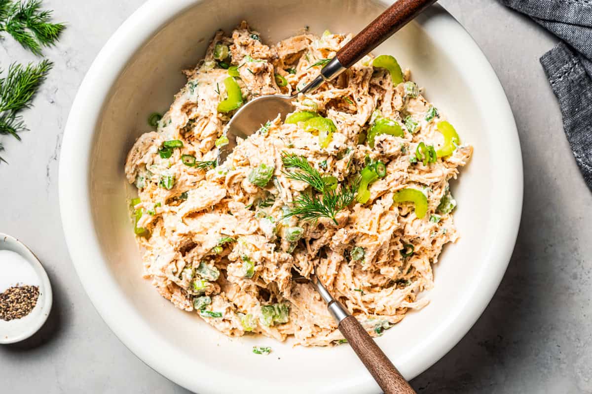 Cottage cheese chicken salad in a bowl with two wooden spoons.