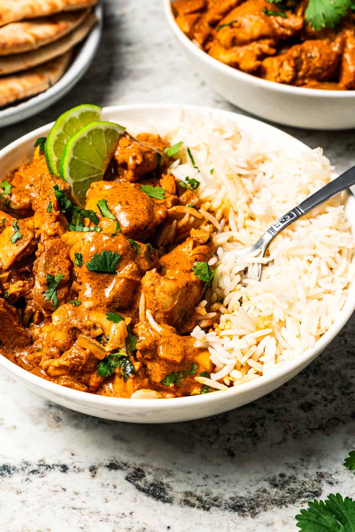 A bowl of slow cooker butter chicken served with rice.