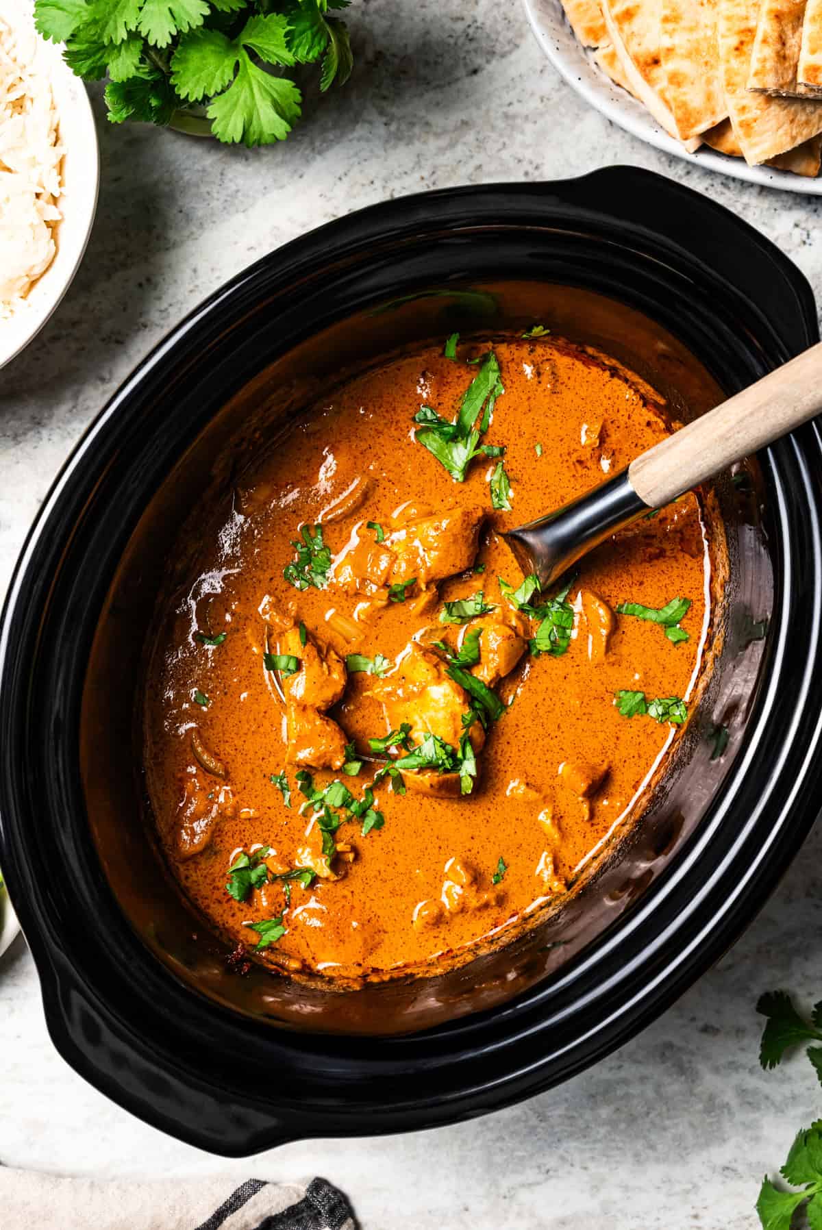 Butter chicken inside the insert of the slow cooker.