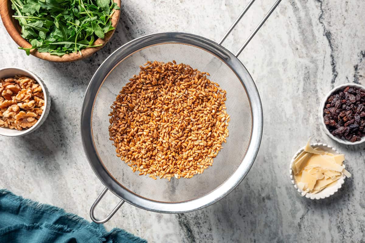 Drained farro in a mesh sieve.