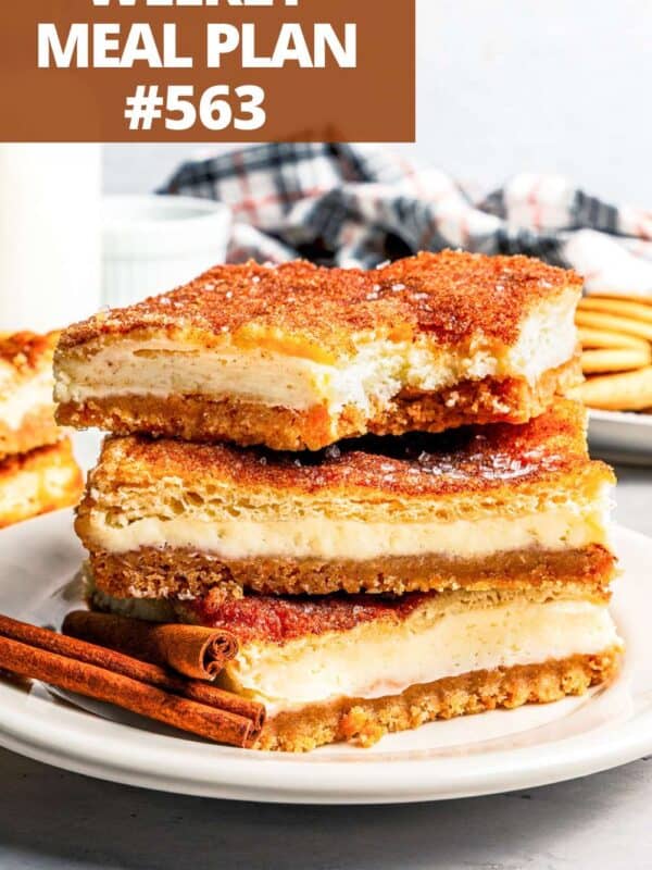 A stack of three churro cheesecake bars on a plate.