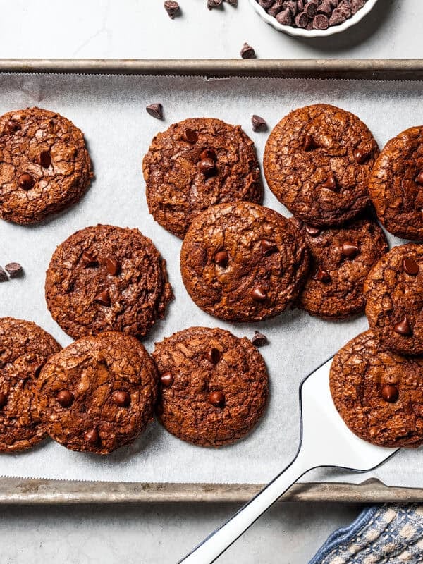 Overhead view of chocolate brownie cookies on a baking sheet.