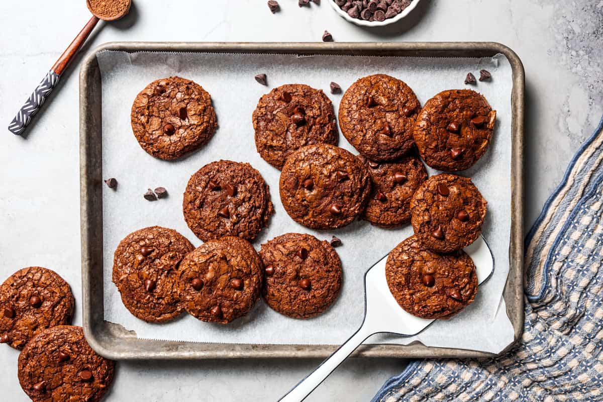 These chewy brownie cookies are the best of a fudgy brownie crossed with a soft-baked chocolate cookie! Made with real melted chocolate. Overhead view of chocolate brownie cookies on a baking sheet.