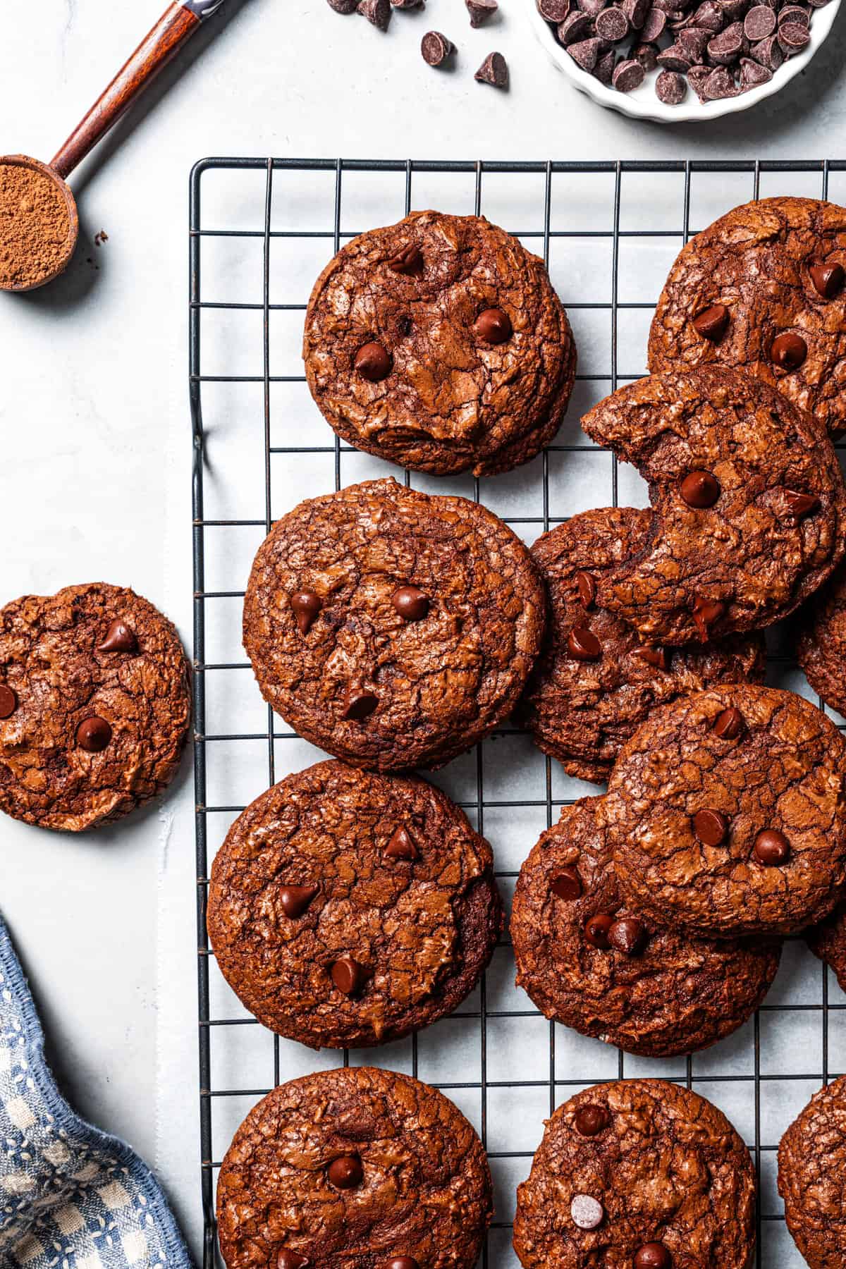 These chewy brownie cookies are the best of a fudgy brownie crossed with a soft-baked chocolate cookie! Made with real melted chocolate. Freshly baked brownie cookies on a wire rack.