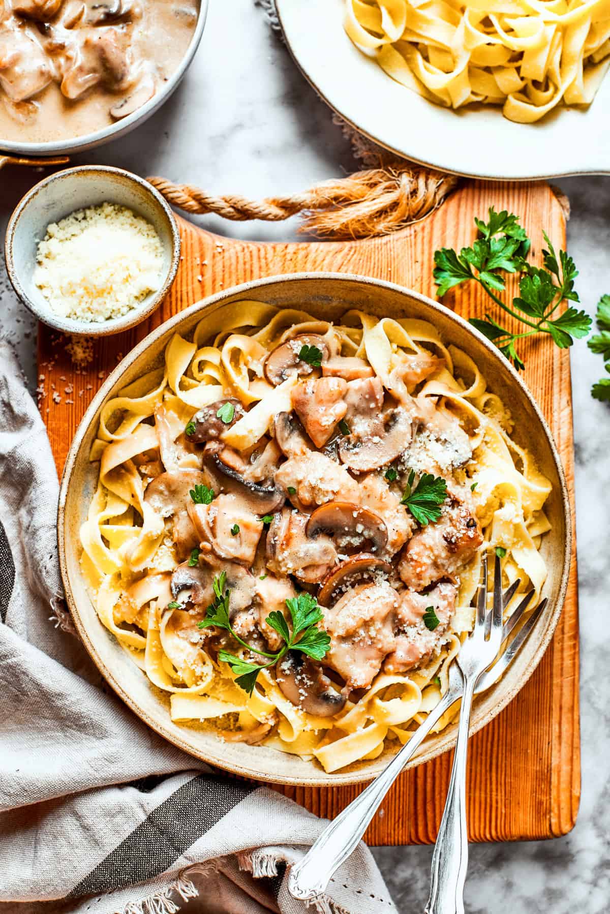 Chopped chicken marsala served over fettuccine in a bowl.