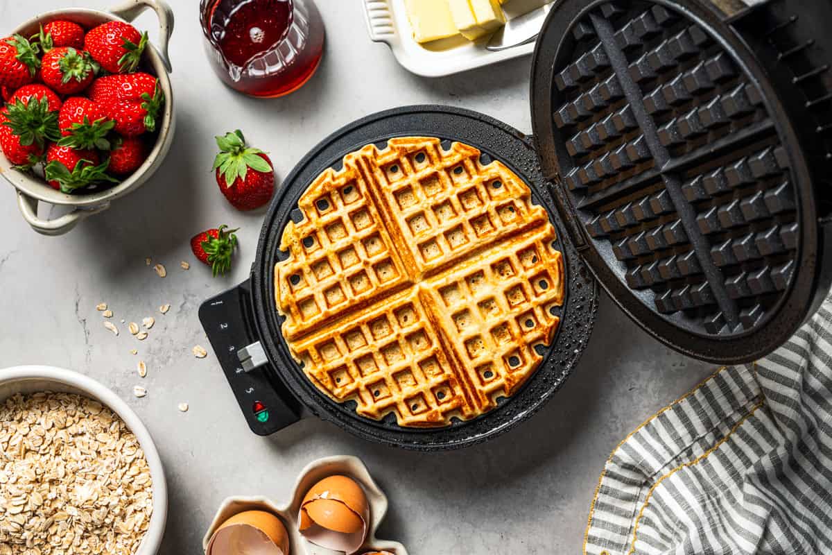 Cooking a waffle in a waffle iron.