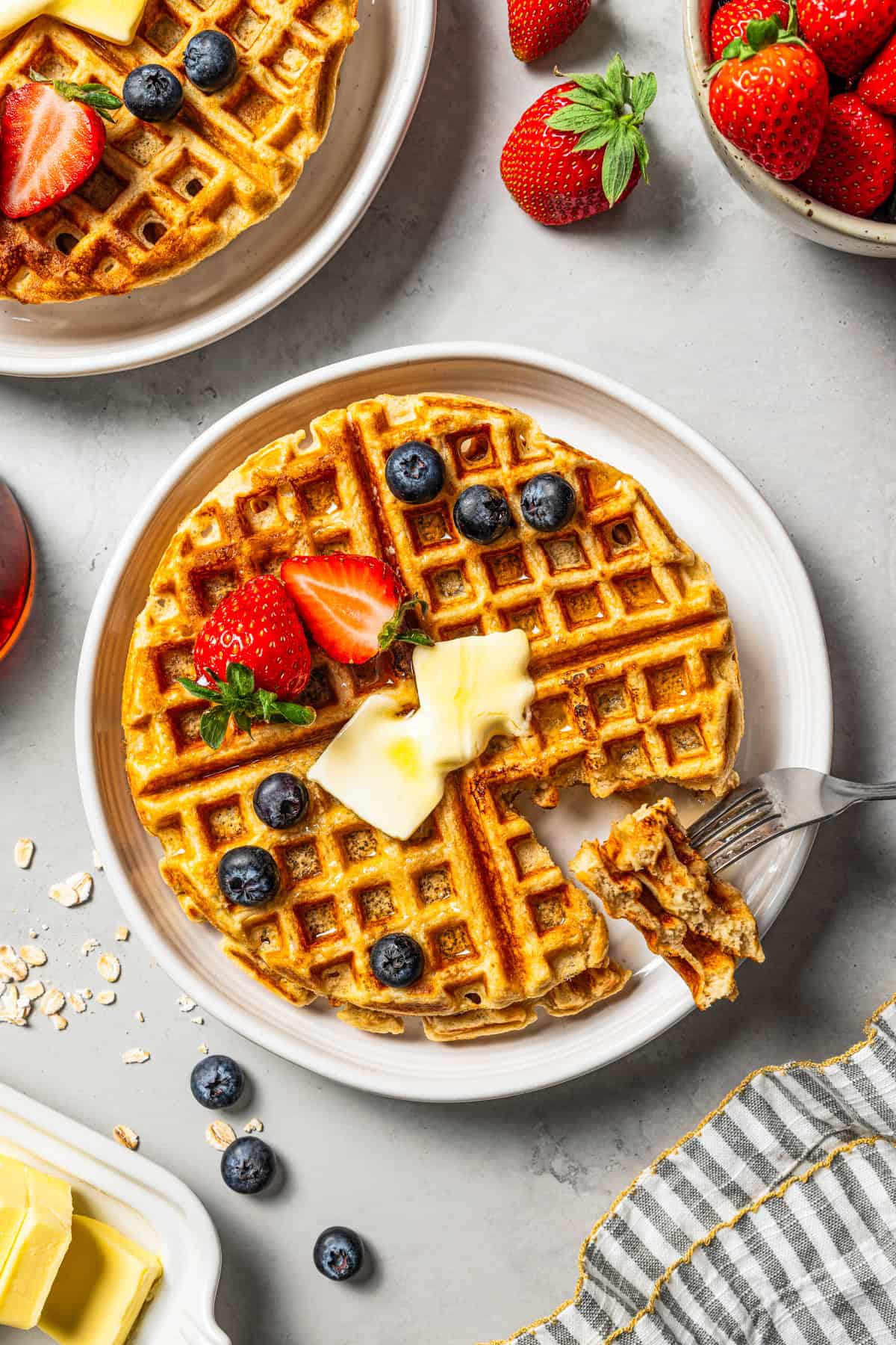 Weekly Meal Plan A forkful of protein waffles held over more waffles on a plate.