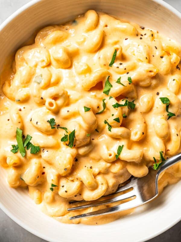 Slow cooker mac and cheese in a bowl with a fork.