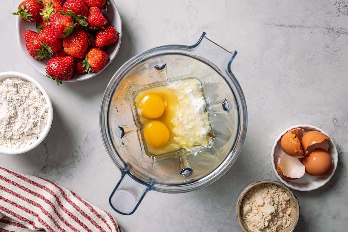 These moist strawberry protein muffins with applesauce, cottage cheese, and protein powder make an easy, light breakfast or meal prep snack! Protein muffin batter ingredients combined in the blender.