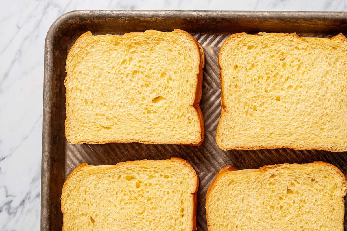 Make this cream cheese stuffed French toast with thick slices of custard-dipped brioche filled with sweet mascarpone and fresh lemon zest. Cream cheese stuffed French toast on a baking sheet.