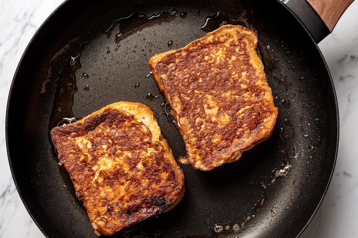 Make this cream cheese stuffed French toast with thick slices of custard-dipped brioche filled with sweet mascarpone and fresh lemon zest. Cooked stuffed French toast in a skillet.