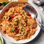 A bowl of shredded chicken tossed with salsa.