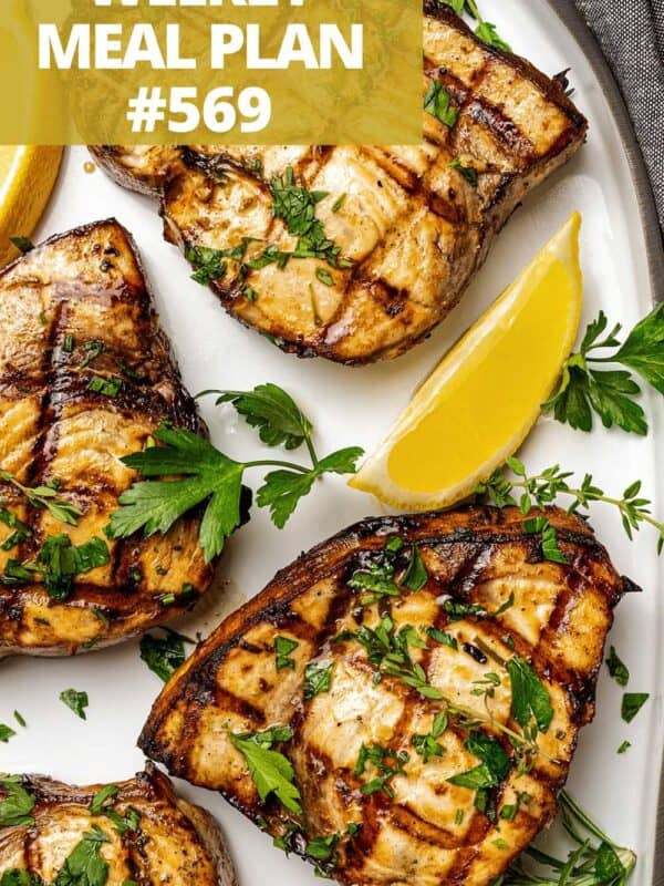 Grilled swordfish fillets on a plate.
