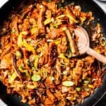 Close up overhead view of Chinese moo shu pork stir fry in a large skillet.