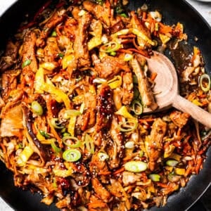 Close up overhead view of Chinese moo shu pork stir fry in a large skillet.