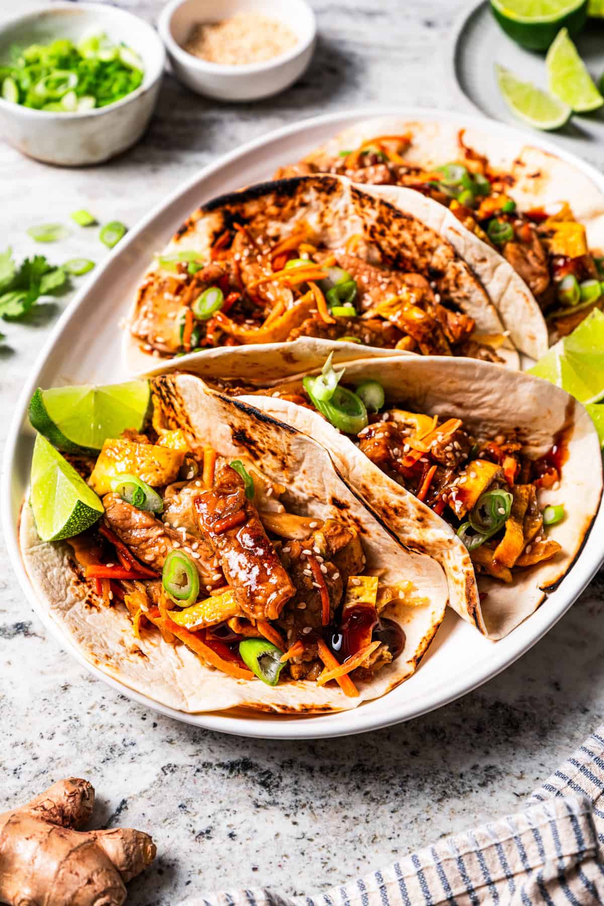 Moo shu pork wraps with hoisin sauce marinade on a platter.