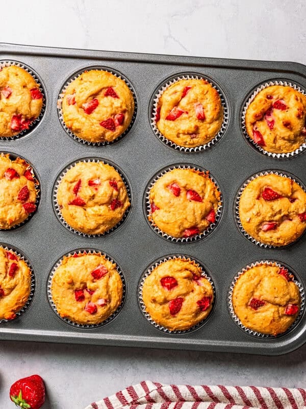Freshly baked protein muffins in a muffin tin.