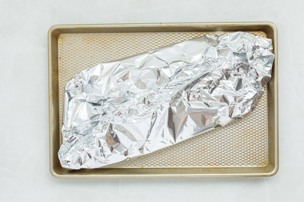 Baked steelhead trout with lemon, butter, garlic, and fresh dill. This easy steelhead trout recipe is tender, flaky, and ready in 30 minutes. Steelhead trout wrapped in foil and set on a baking sheet.