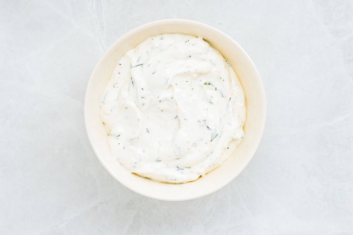 Baked steelhead trout with lemon, butter, garlic, and fresh dill. This easy steelhead trout recipe is tender, flaky, and ready in 30 minutes. A bowl of creamy horseradish dill sauce.