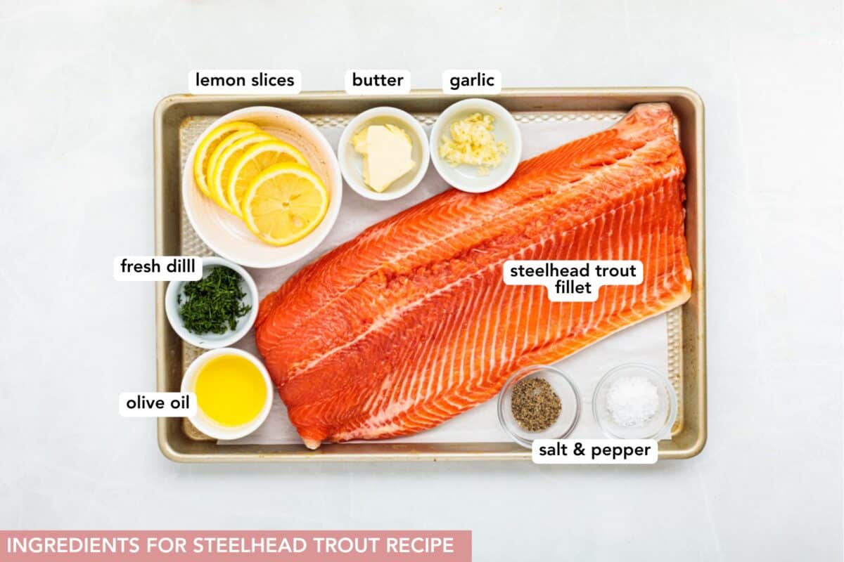 Baked steelhead trout with lemon, butter, garlic, and fresh dill. This easy steelhead trout recipe is tender, flaky, and ready in 30 minutes. Ingredients for baked steelhead trout, with labels.