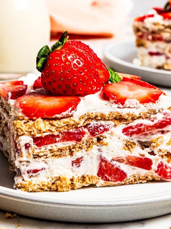 A slice of strawberry icebox cake served on a plate.