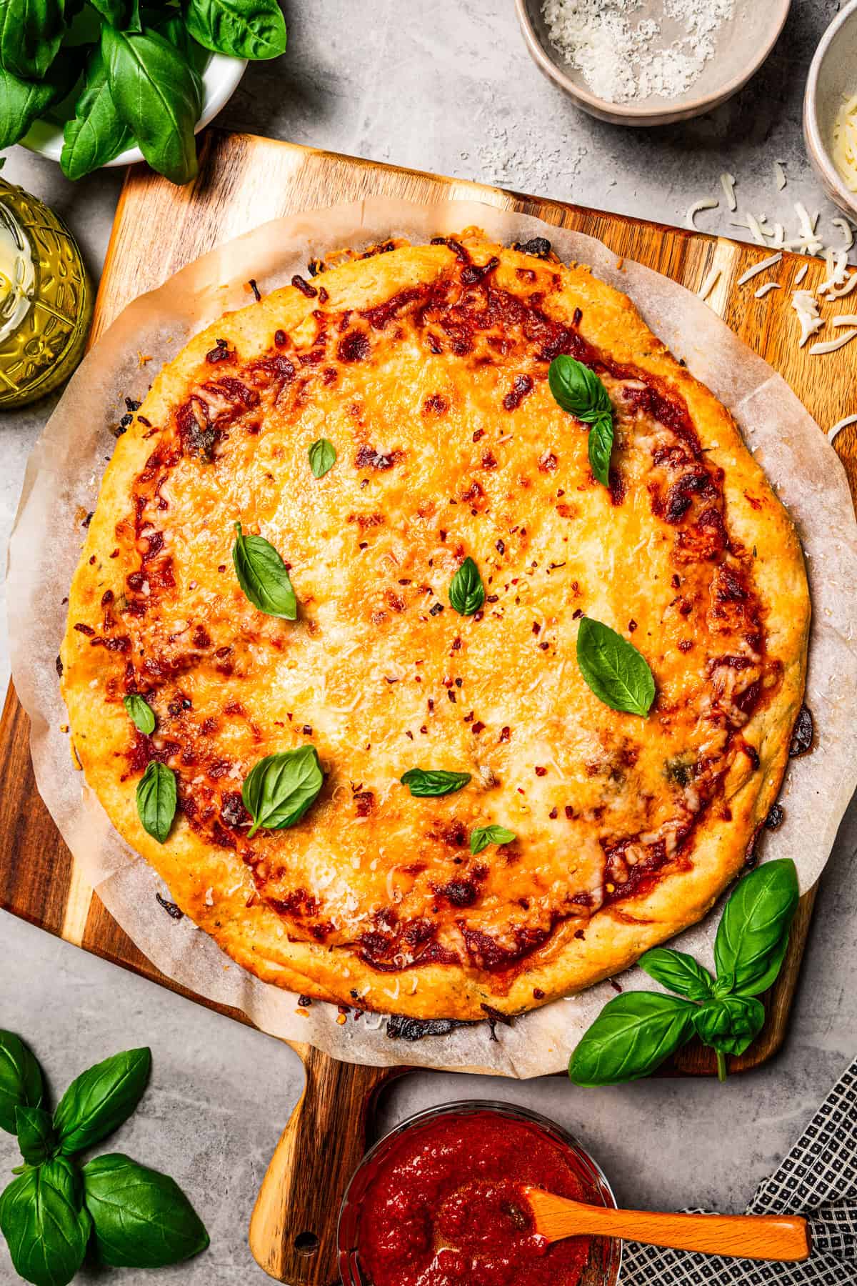 Cottage cheese pizza crust topped with tomato sauce, melty cheese, and fresh basil leaves.