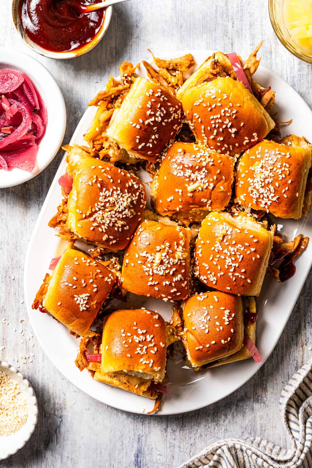 These BBQ pulled pork sliders are sweet, smoky, savory, and easy to make with leftover pulled pork, melted cheese, and fluffy Hawaiian rolls. BBQ pulled pork sliders served on a platter.