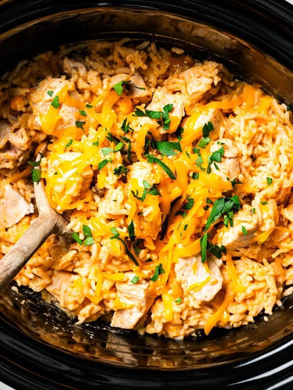 Overhead view of cheesy cream of mushroom chicken and rice in the slow cooker.