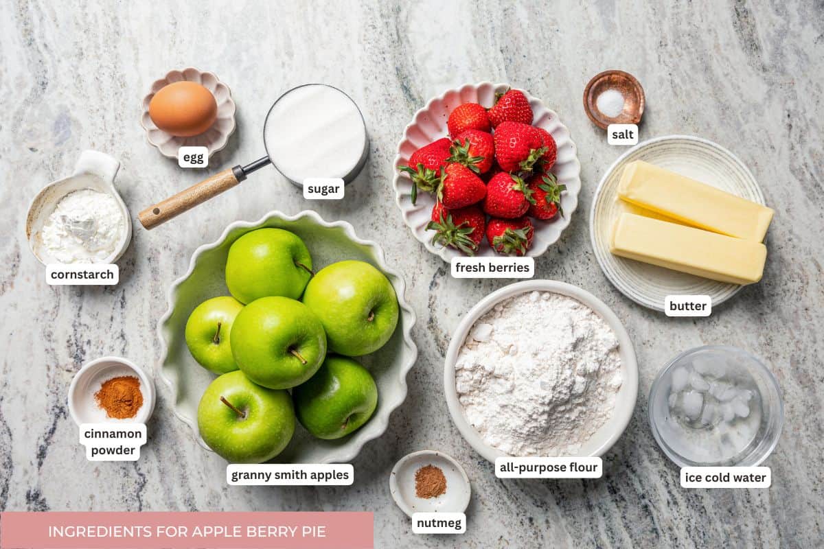 Apple berry pie is the perfect dessert to go from summer to fall! A cozy homemade apple pie bursting with fresh berries in a flaky pie crust. Apple berry pie ingredients with text labels.