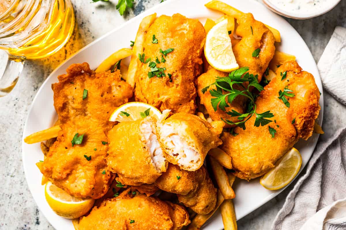 Make beer-battered fish with easy ingredients! This crispy, flaky fried white fish is perfect for tacos, pub-style fish and chips, and more. A plate of beer-battered fish.