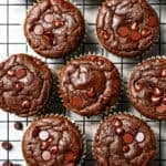 Chocolate protein muffins cooling on a wire rack.