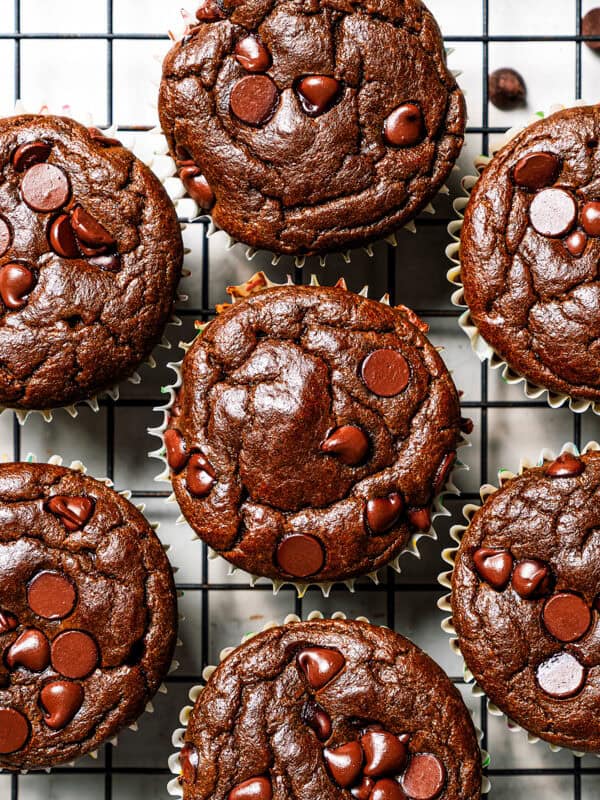 Chocolate muffins cooling on a wire rack.