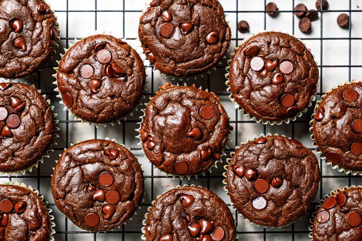 Chocolate protein muffins are moist, loaded with hidden veggies, and easy to make in the blender for a high-protein breakfast or meal prep. Chocolate muffins cooling on a wire rack.