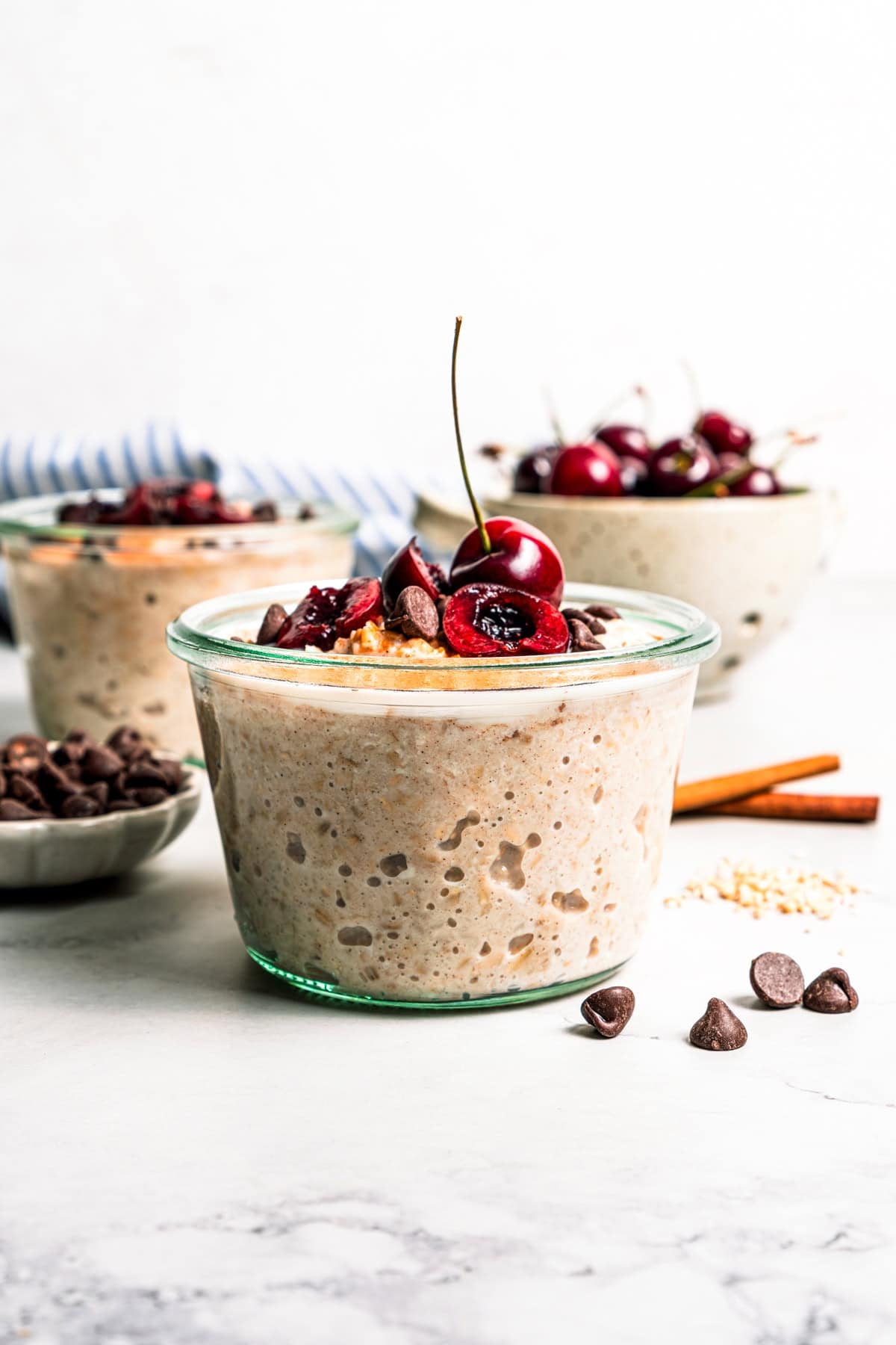 This easy overnight steel-cut oats recipe combines chewy oats, milk, vanilla, and cozy cinnamon into a delicious make-ahead breakfast. Creamy overnight steel cut oats in jars.
