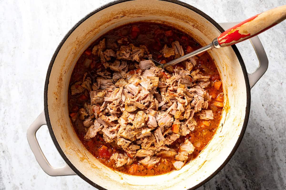 This slow-braised pork ragu recipe cooks for hours in the oven until fall-apart tender and ready to shred into a rich, flavorful meat sauce. Shredded pork shoulder added back into the pot to make ragu sauce.