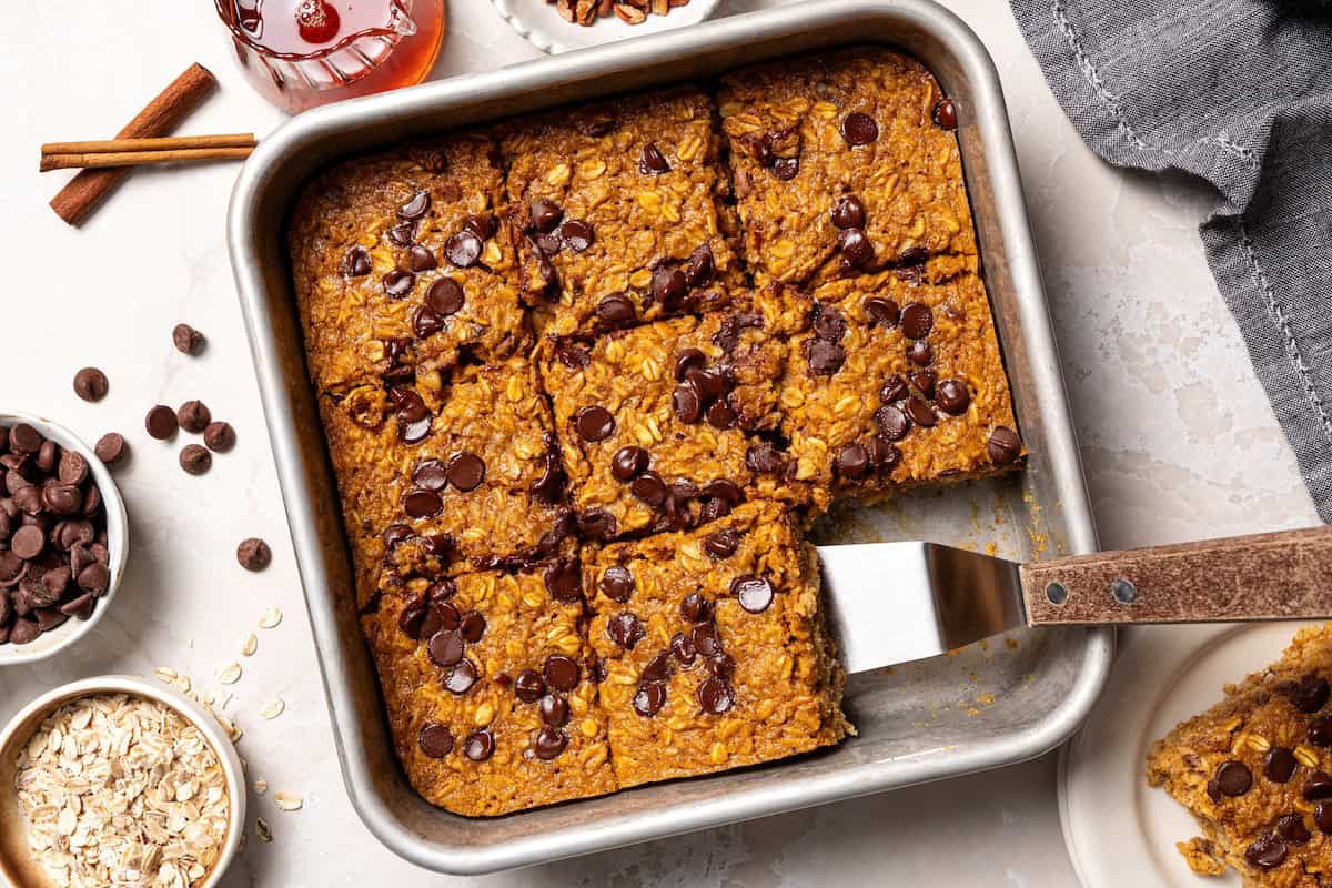 Pumpkin baked oatmeal is the perfect easy, make-ahead fall breakfast! Filled with hearty oats, warm spices, pumpkin purée, and maple syrup. Baked pumpkin oatmeal sliced and ready to serve.