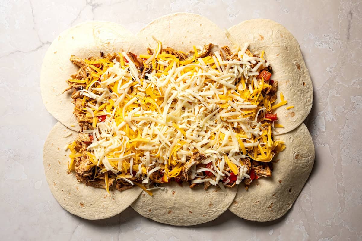 Assembling the quesadillas on a sheet pan.