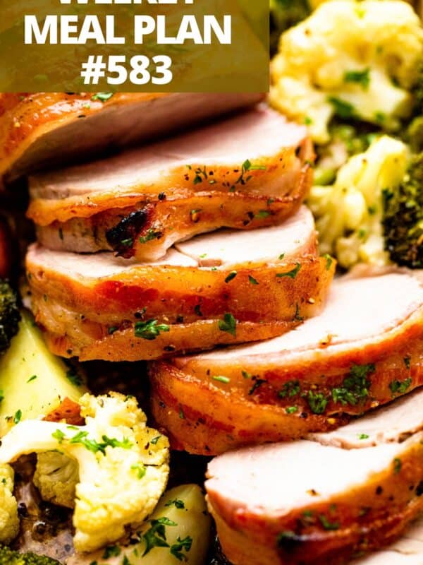 Sliced pork tenderloin set over vegetables.