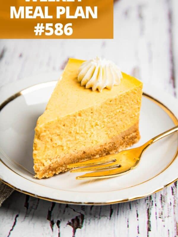 A slice of instant pot pumpkin cheesecake served on a dessert plate, with a fork set right next to it.