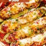 Halved zucchini boats stuffed with taco meat and melty cheese on top.