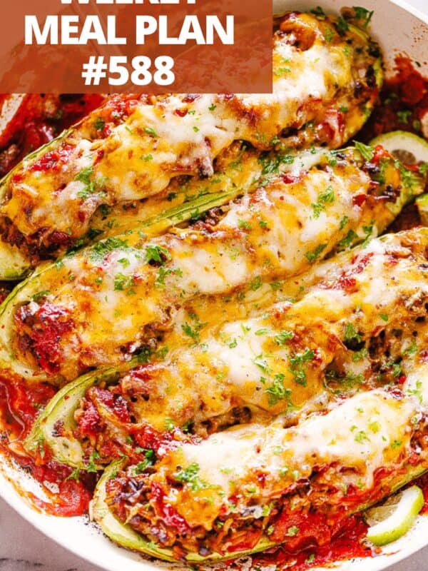 Halved zucchini boats stuffed with taco meat and melty cheese on top.