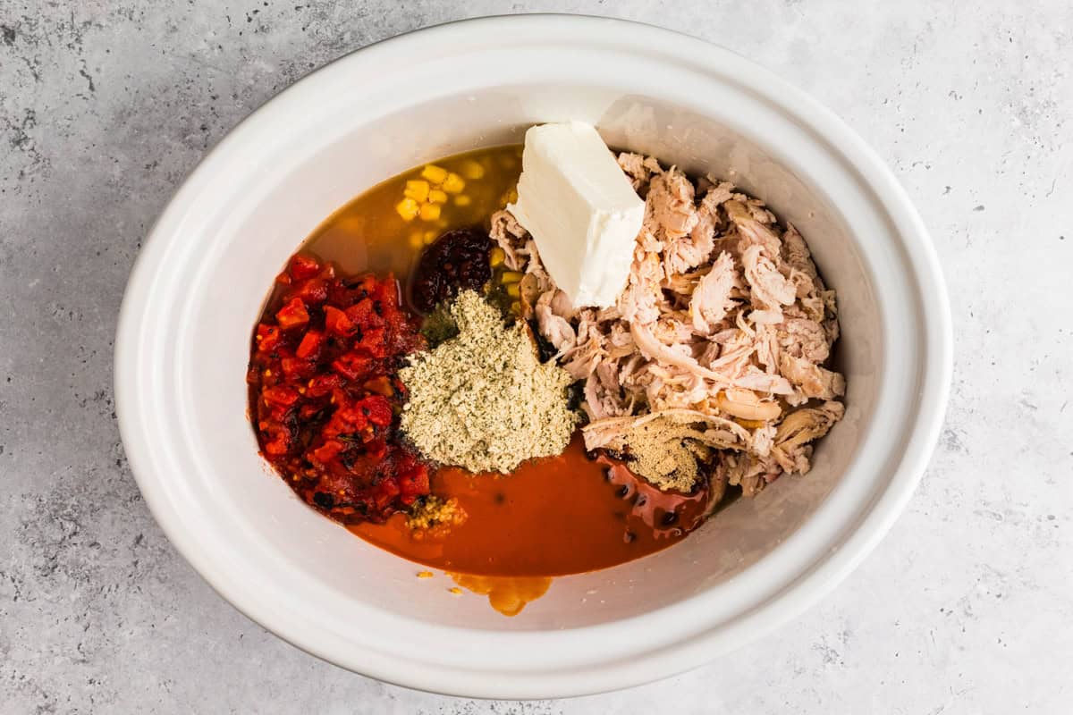 Thick and creamy Buffalo chicken chili made with shredded chicken, beans, Buffalo sauce, and cream cheese. An easy crockpot chili, perfect for weeknights or game day! Shredded chicken, cream cheese, Buffalo sauce, tomatoes, and seasonings added to a slow cooker.
