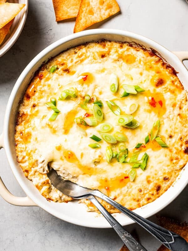 Baked crab rangoon dip topped with melted cheese, and served with crispy wonton chips.