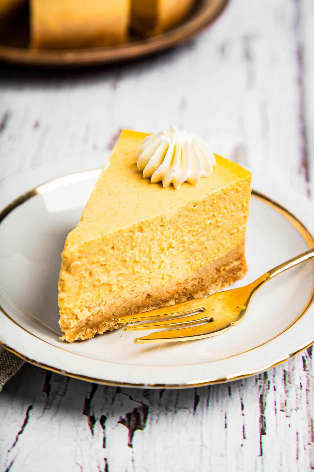 Weekly Meal Plan A slice of pumpkin cheesecake served on a dessert plate.