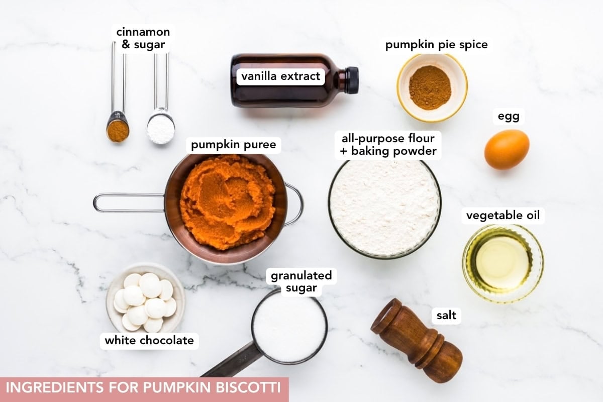 A photo of pumpkin biscotti ingredients arranged on a light-colored surface.