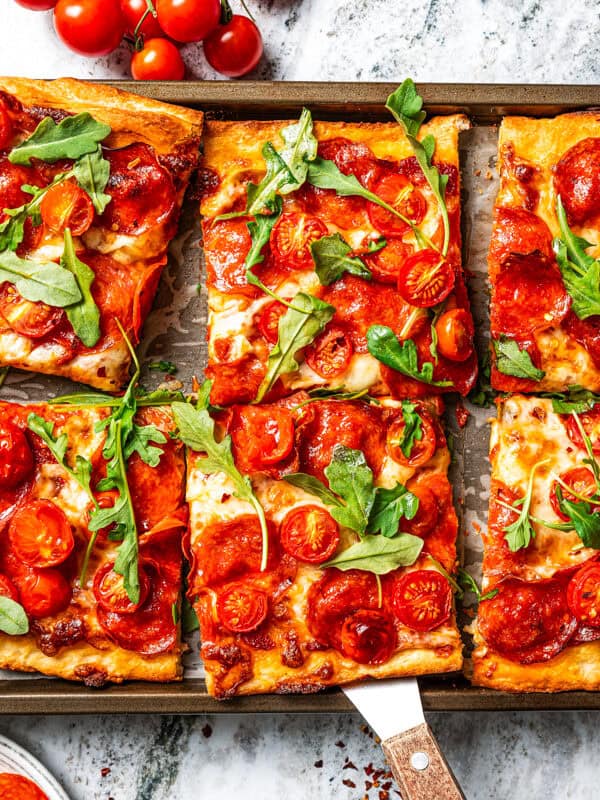 Sheet pan pizza cut into squares.